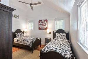 Bedroom with twin beds, ceiling fan, and vaulted ceiling