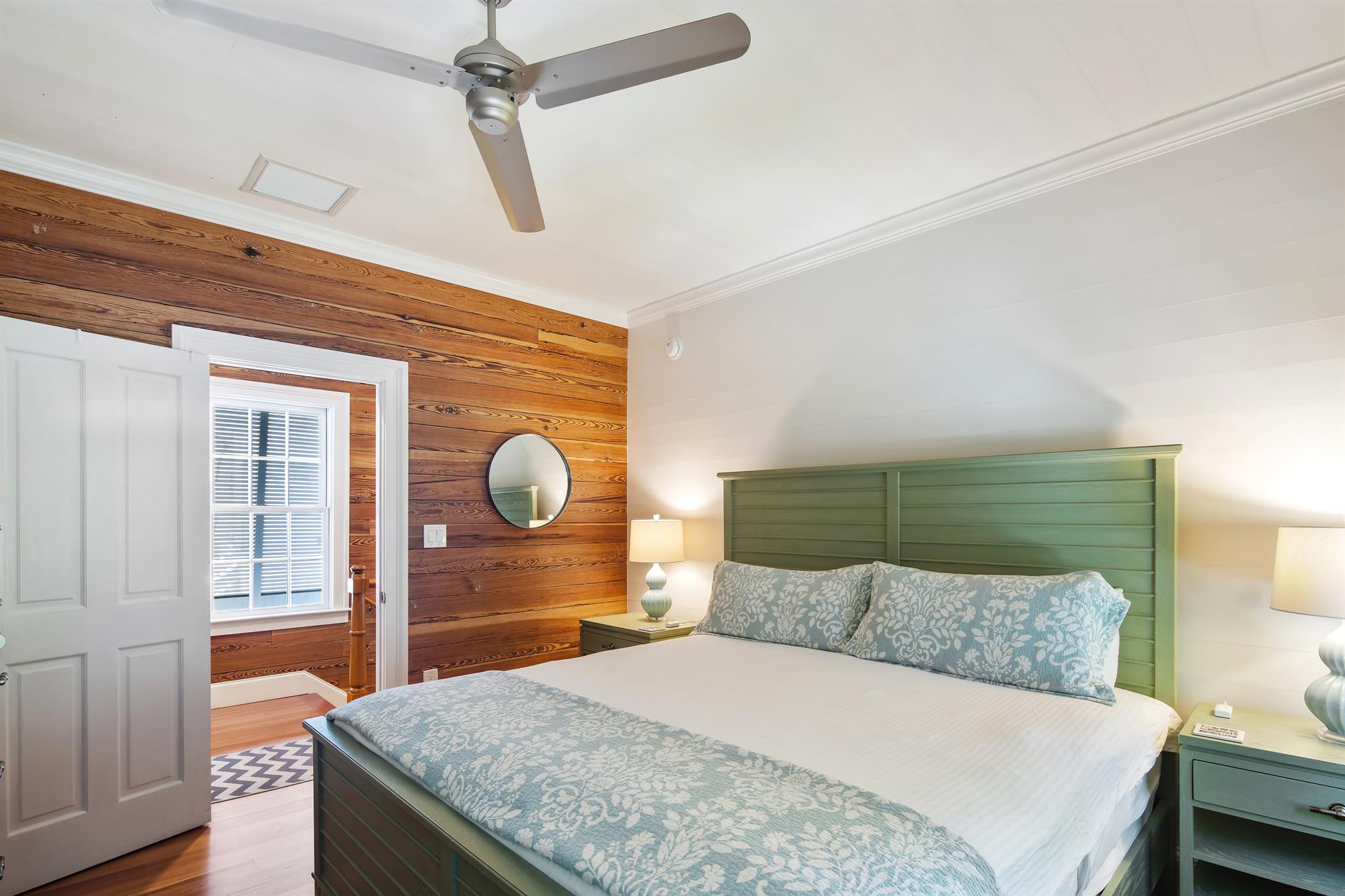 King bedroom with ceiling fan and dual night stands