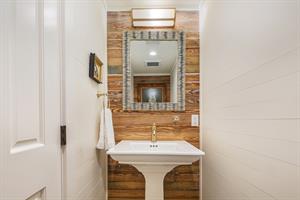 Powder room is located just off the kitchen area.