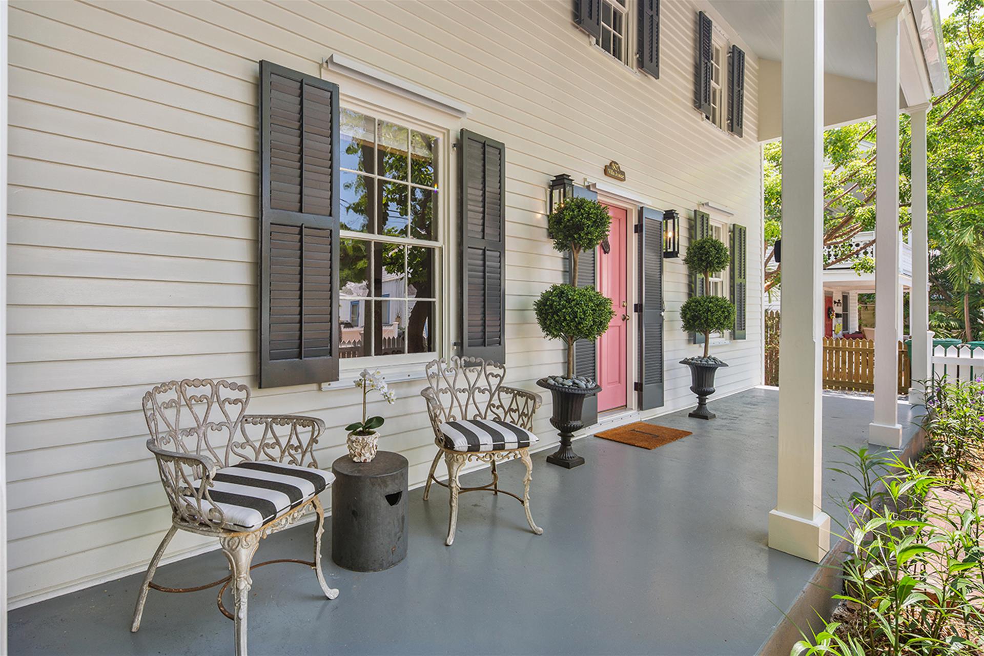 Pleasant front porch offers seating for two.