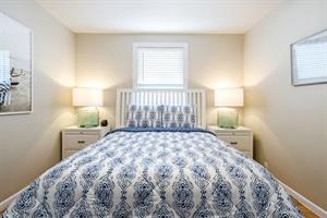 Second bedroom has a queen bed and colorful linens.