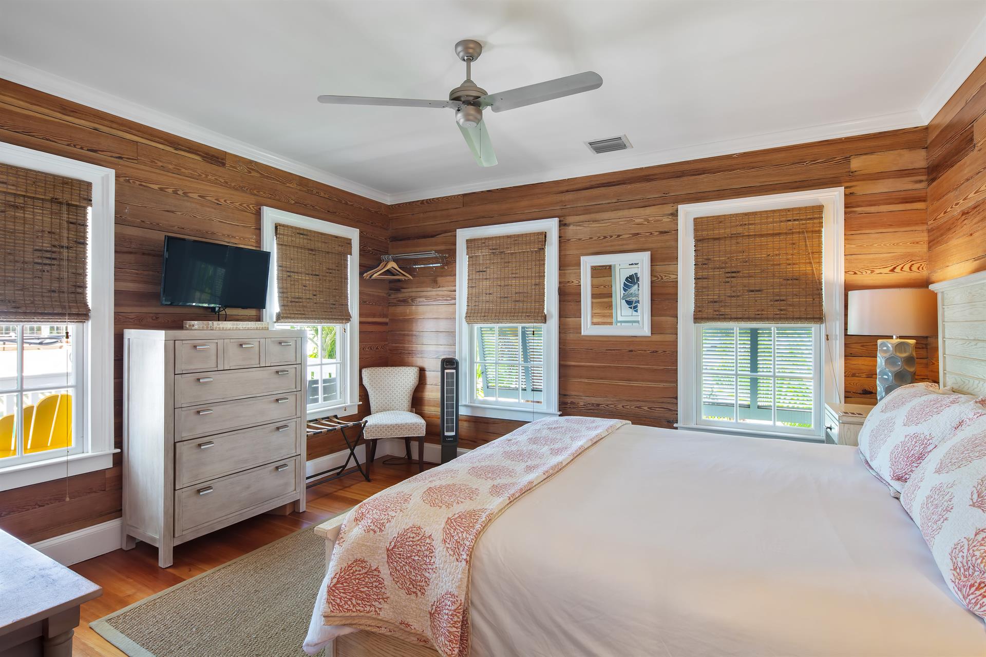 Spacious primary bedroom boasts a King bed and balcony access.