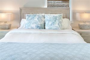 King bed with dual nightstands and bedside lighting.