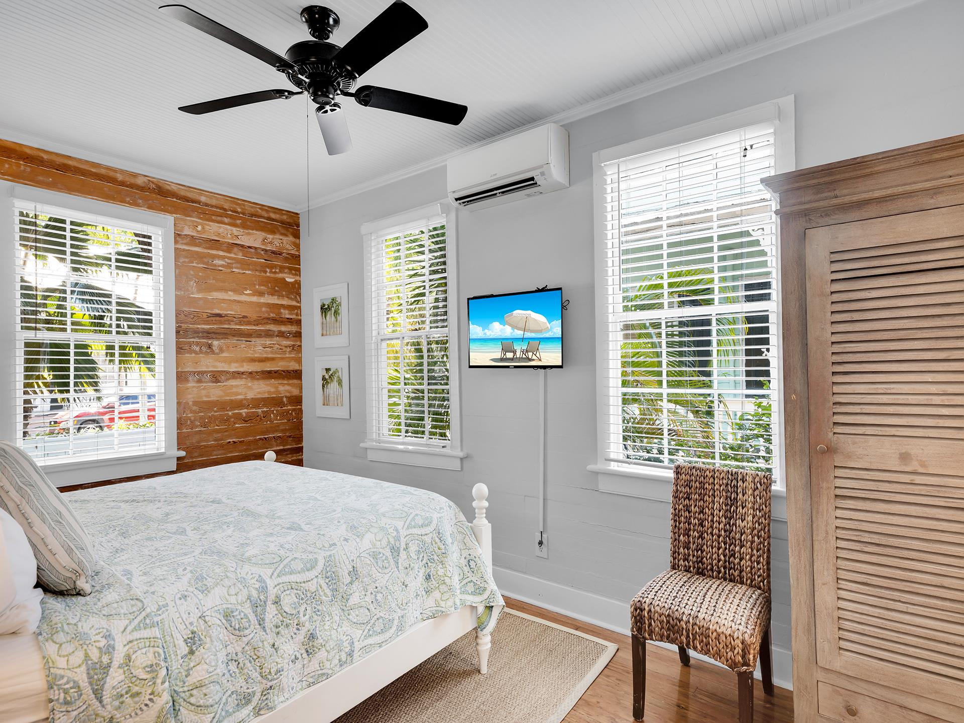 First floor bedroom includes TV,  AC  ceiling fan.