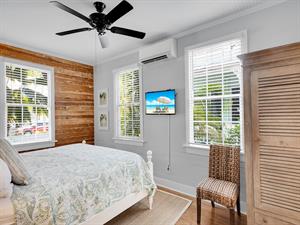 First floor bedroom includes TV,  AC  ceiling fan.