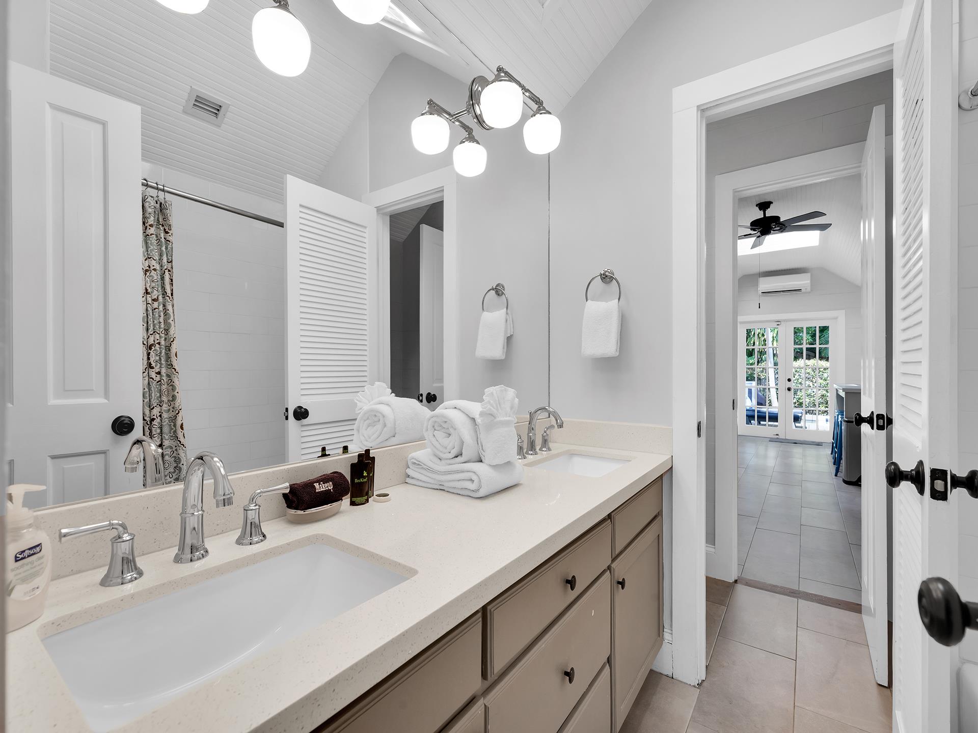 Spacious full bath accessed by bedroom or kitchen.