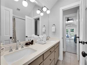 Spacious full bath accessed by bedroom or kitchen.