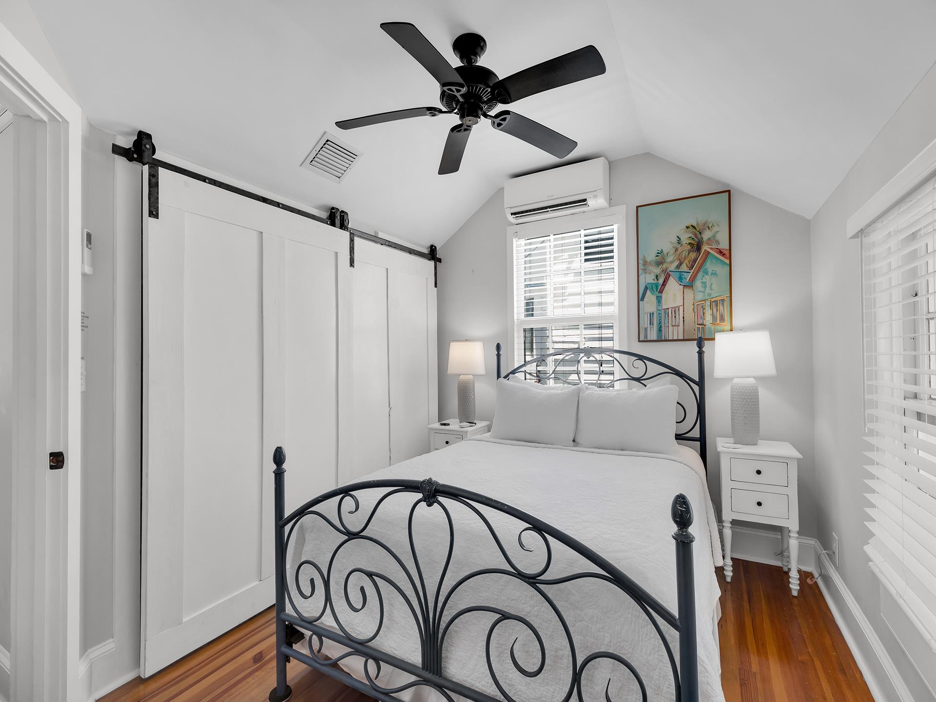 Queen bedroom with sliding barn door closet  vaulted ceiling.