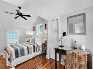 Second upstairs bedroom with comfy queen size bed and desk.