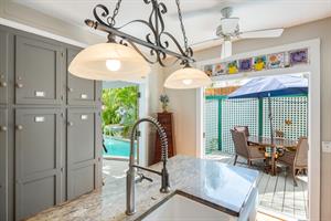 Outdoor dining access just steps from the kitchen and pool area