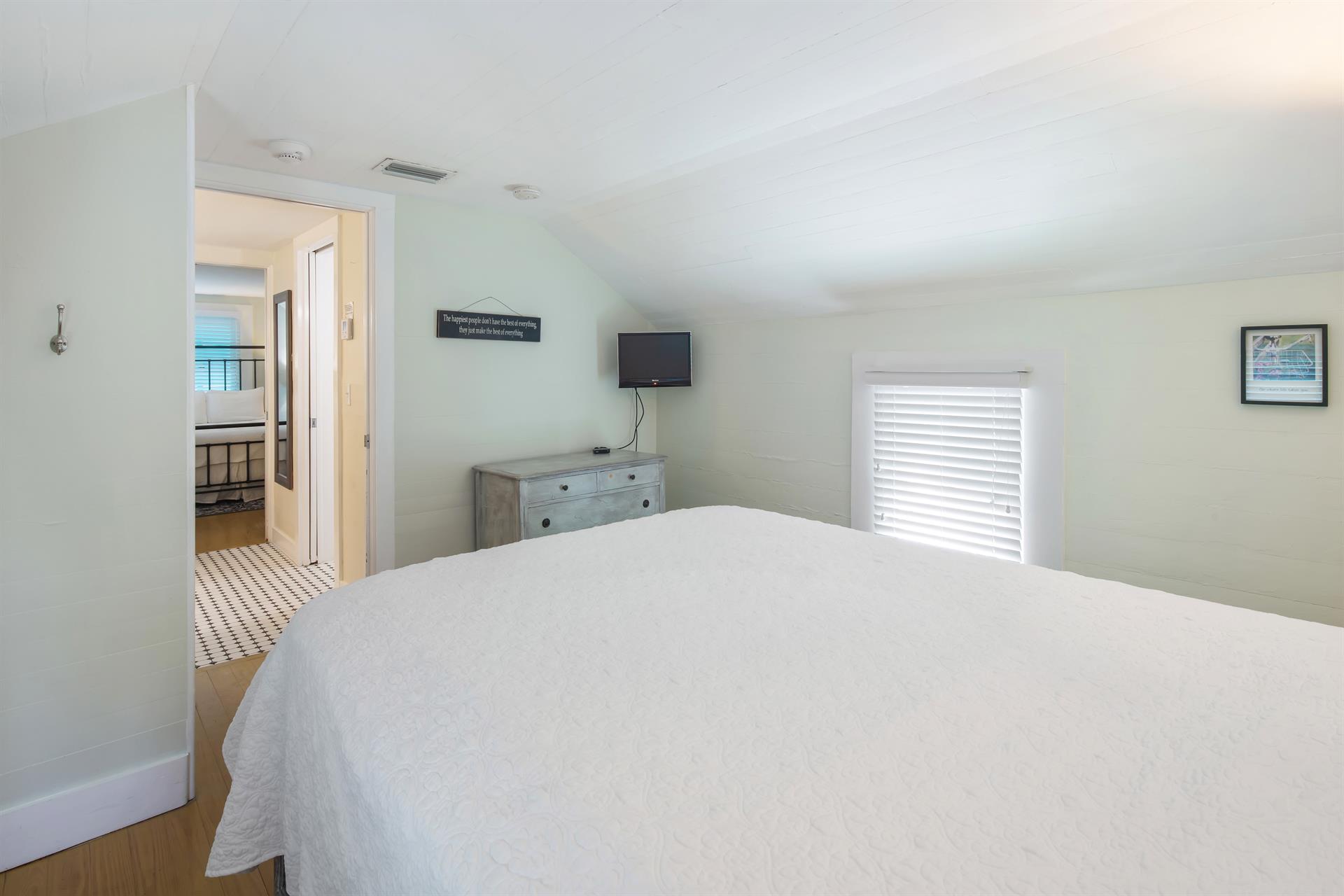 Third bedroom with queen bed, TV and dresser