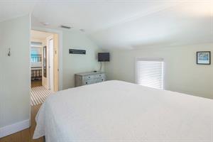 Third bedroom with queen bed, TV and dresser
