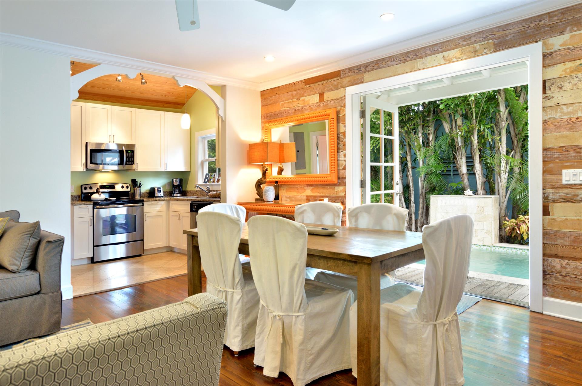 Indoor dining for 6 with French doors leading to the pool area.