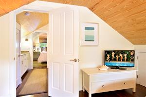 Second floor twin bedroom with TV and shared bath.