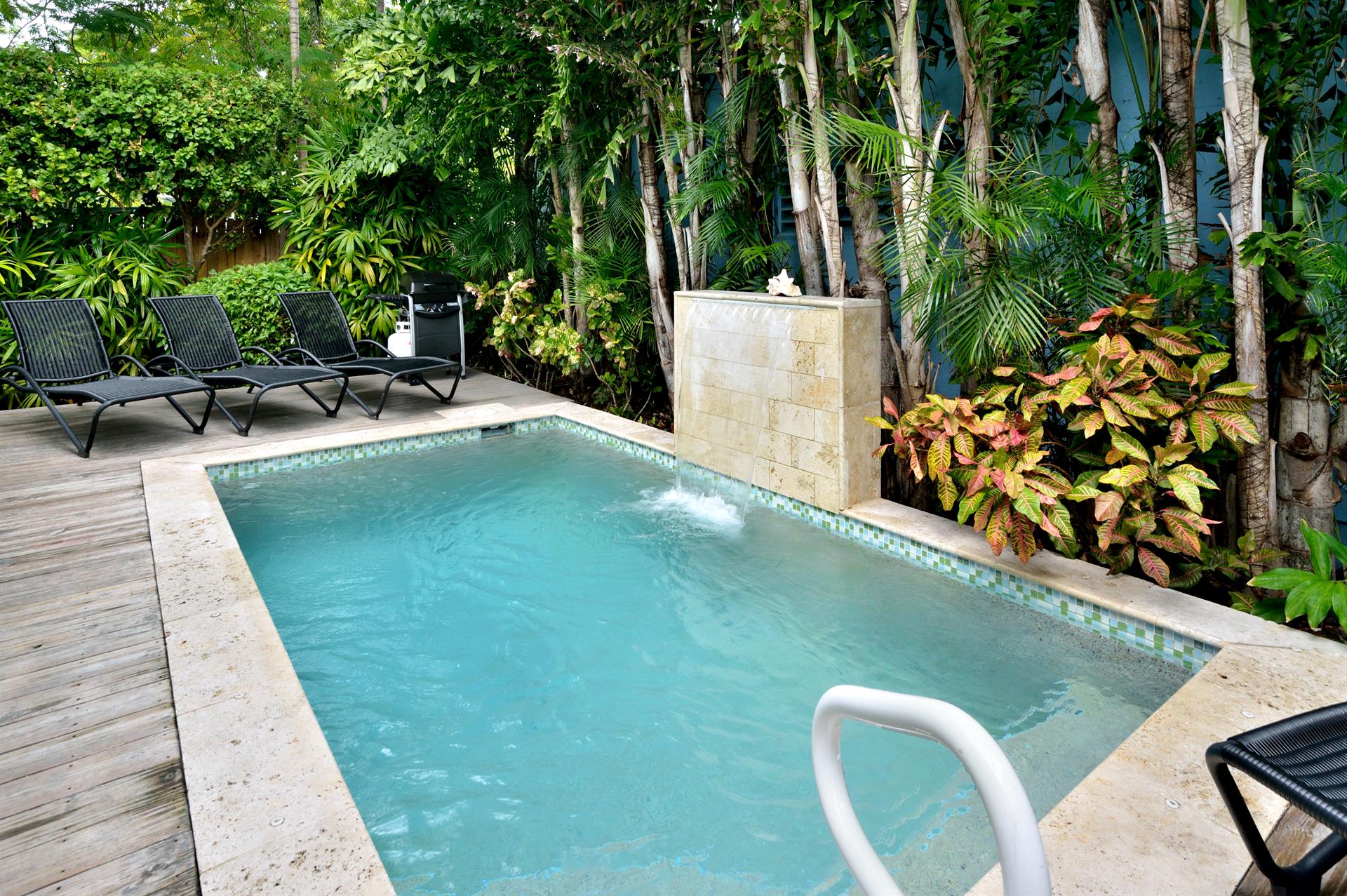 Private, seasonally heated pool with waterfall feature.