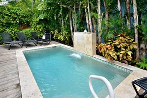 Private, seasonally heated pool with waterfall feature.