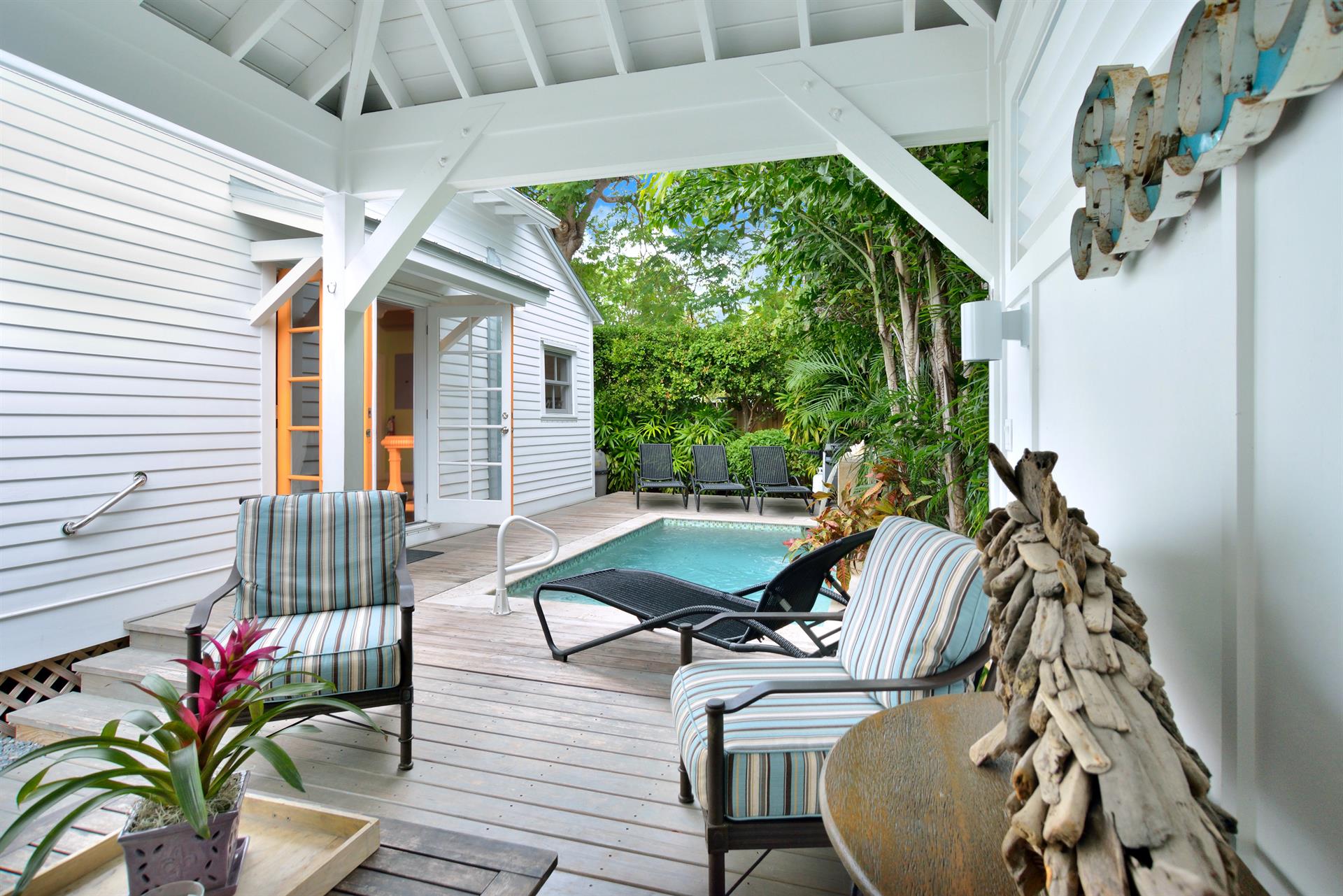 Breezy poolside cabana, private pool with water feature.