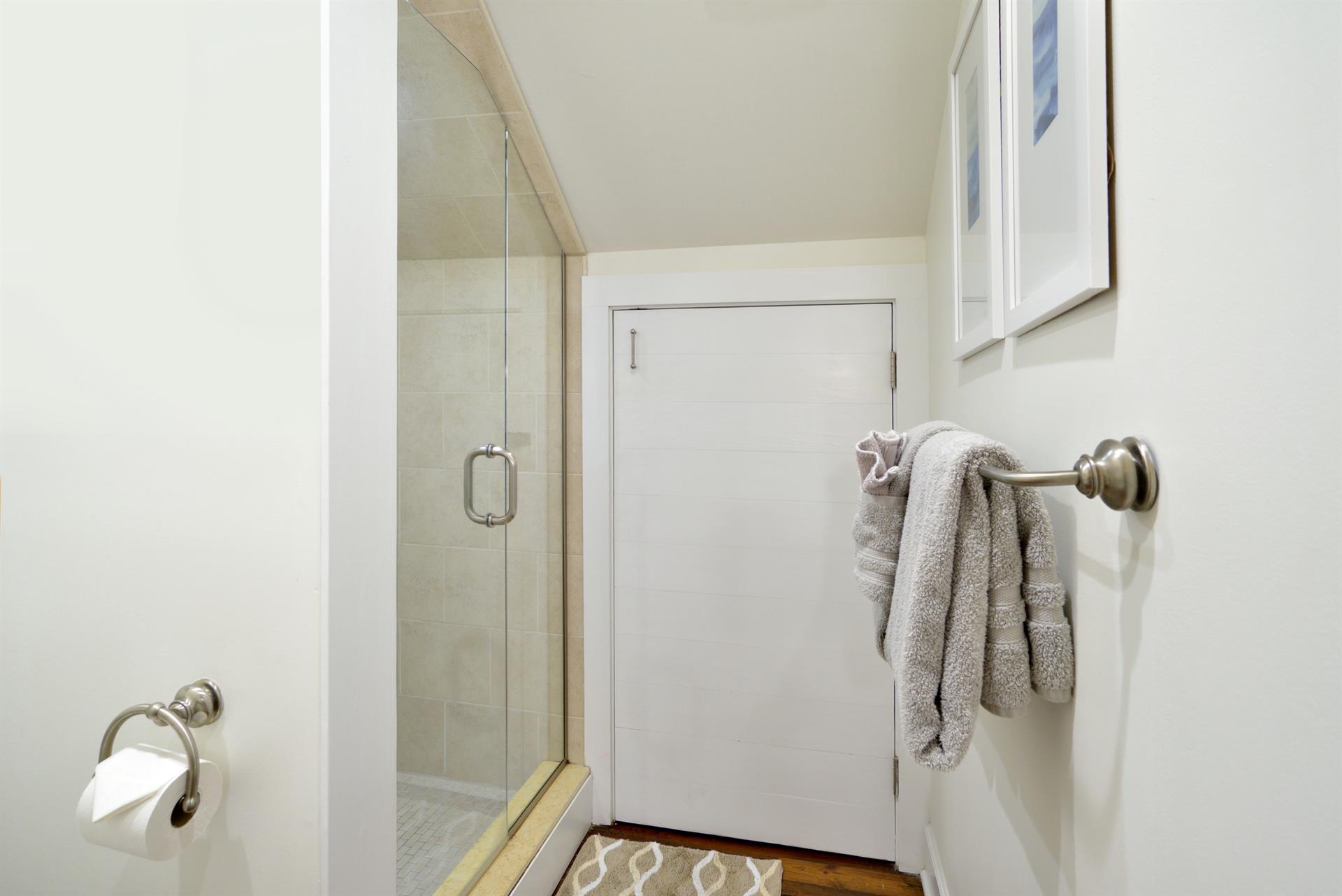 Shared second floor bath with glassenclosed shower.