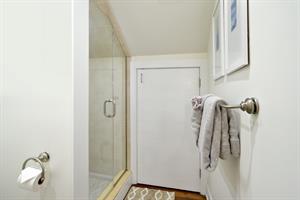 Shared second floor bath with glassenclosed shower.