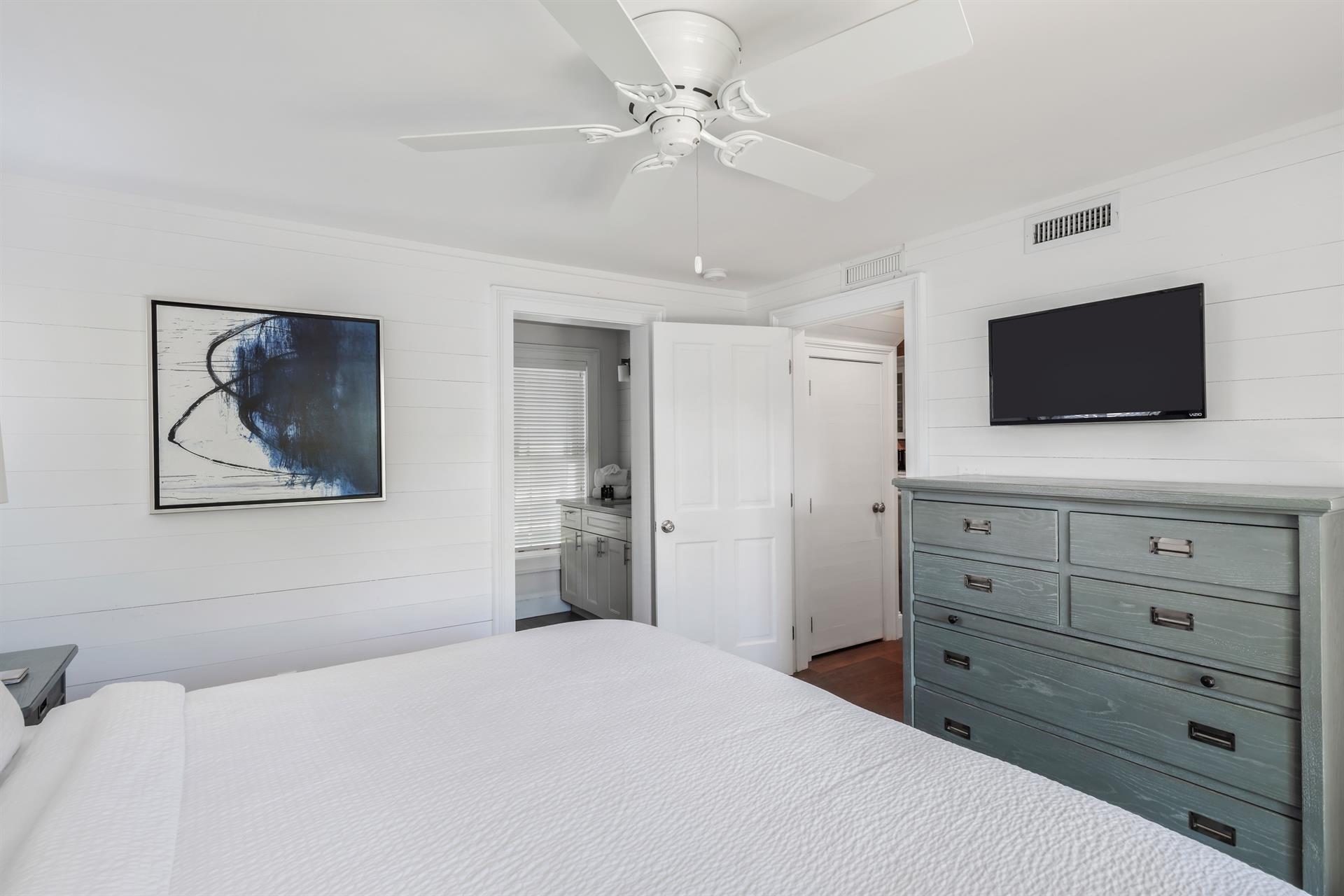 King bedroom with dresser and TV
