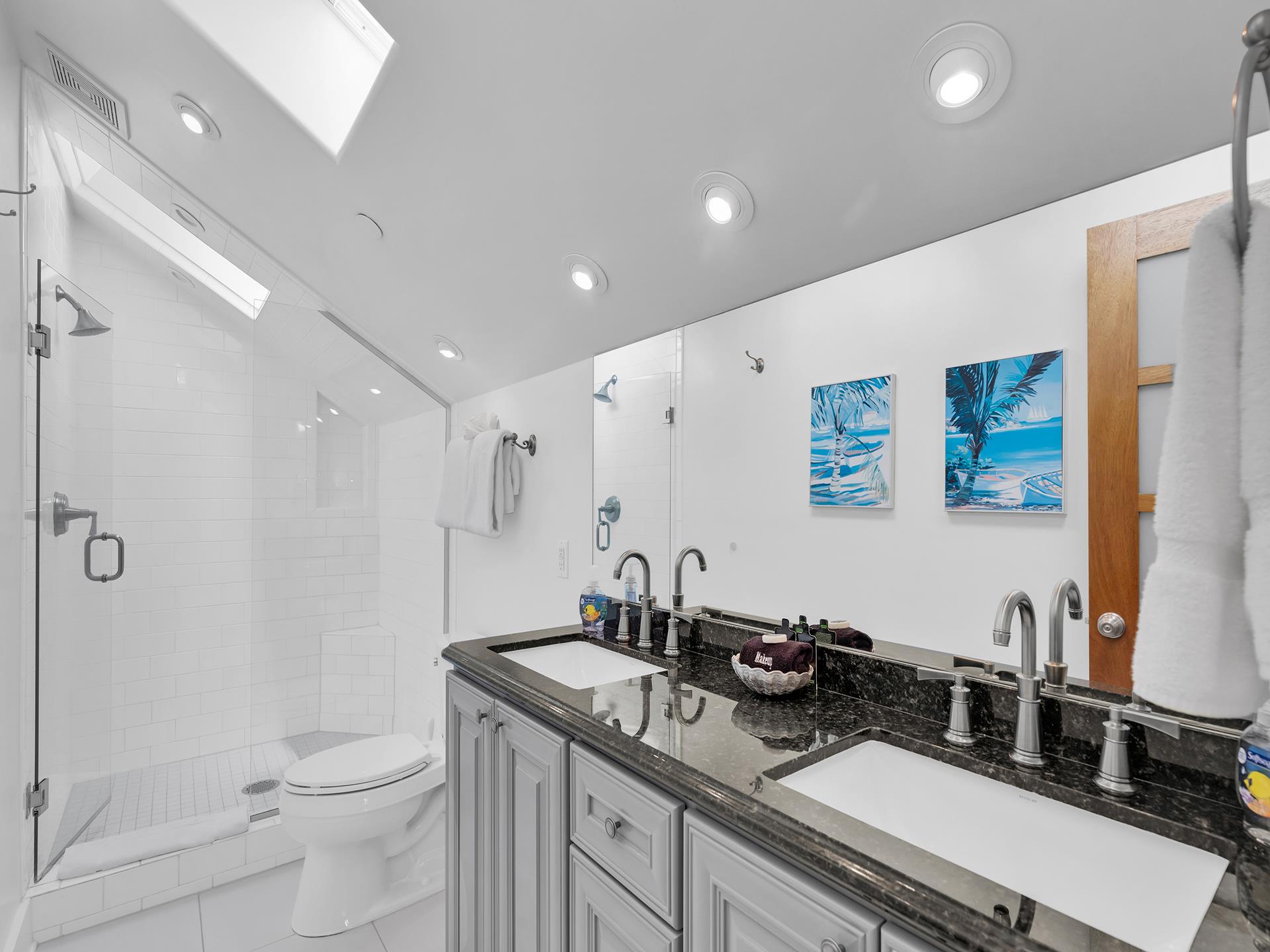 Third floor ensuite bath with double sinks.