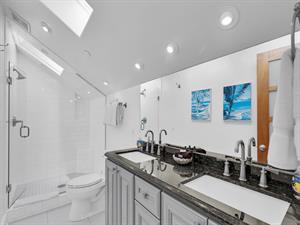 Third floor ensuite bath with double sinks.