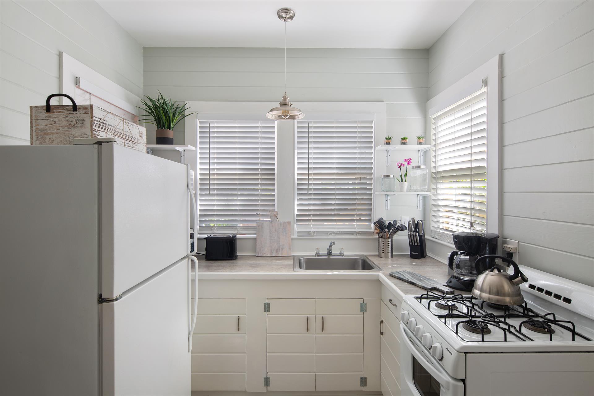 Clean  pristine kitchen, with everything you need