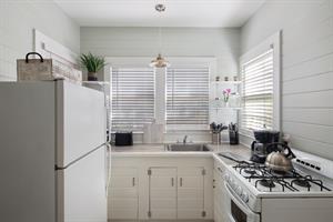 Clean  pristine kitchen, with everything you need