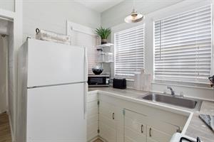 Quaint kitchen for meal or snack prep.