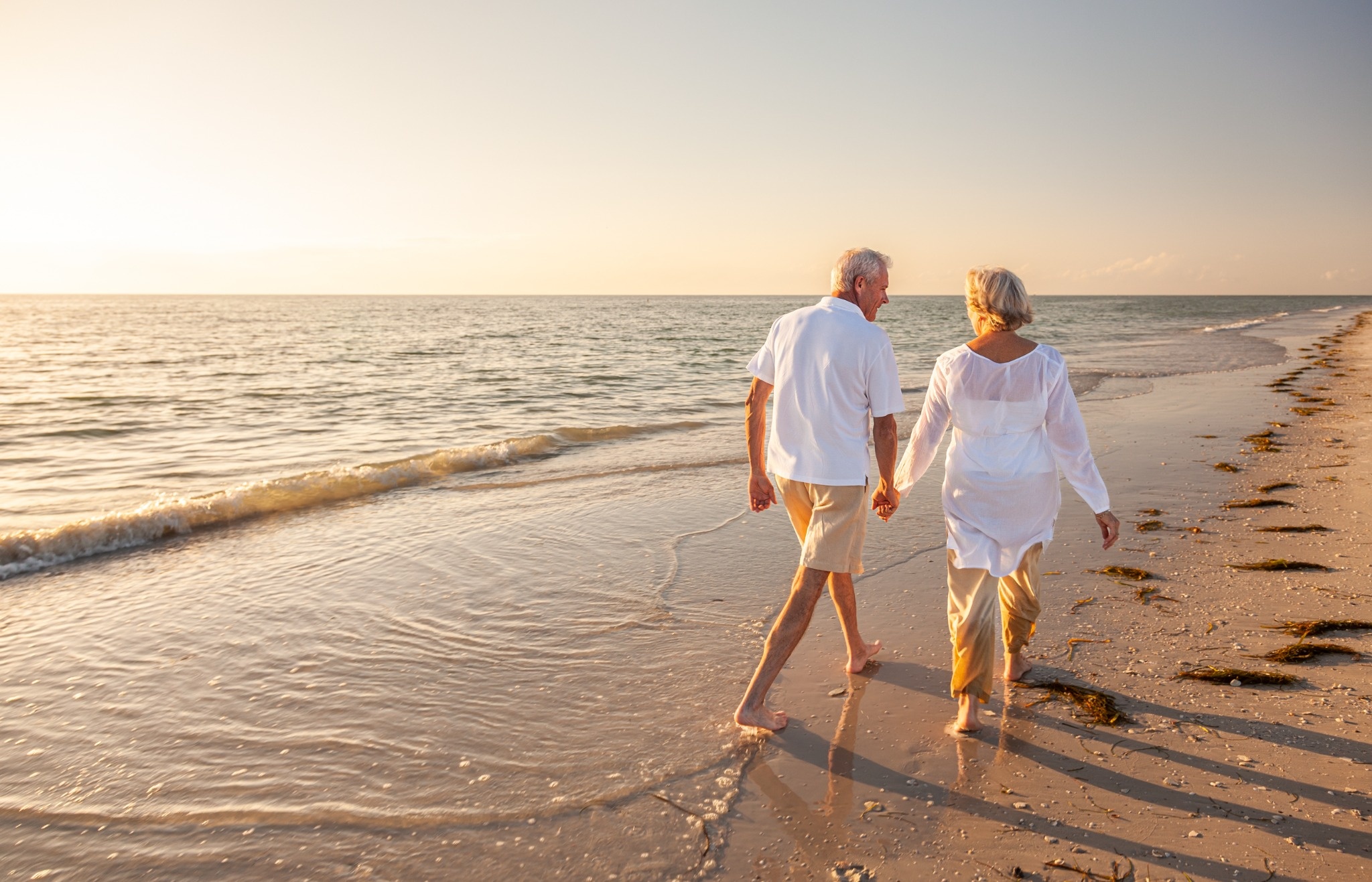 Couple walking along the beach on St. Simons Island in winter