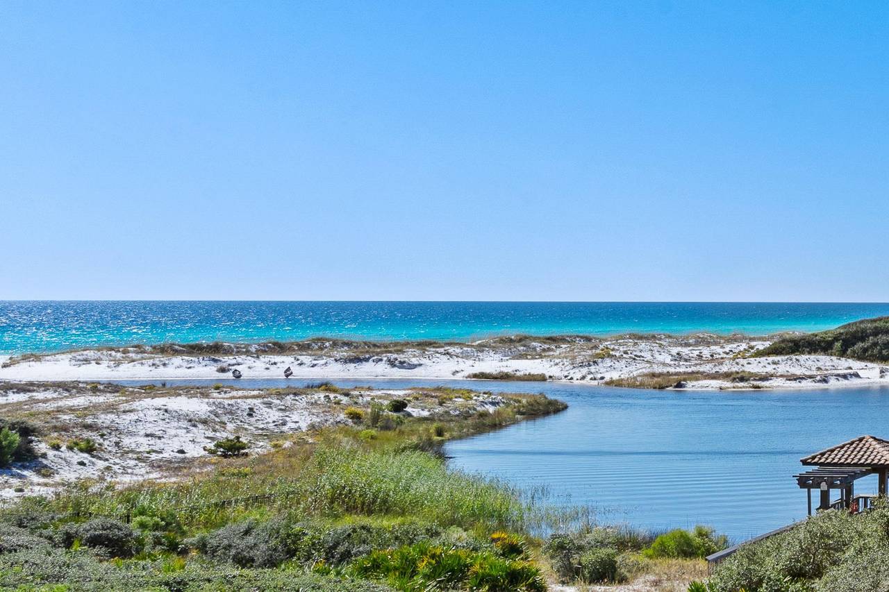 Stunning coastal landscape featuring pristine white sand beaches, crystalclear turquoise waters, and peaceful lagoon views with natural vegetation.