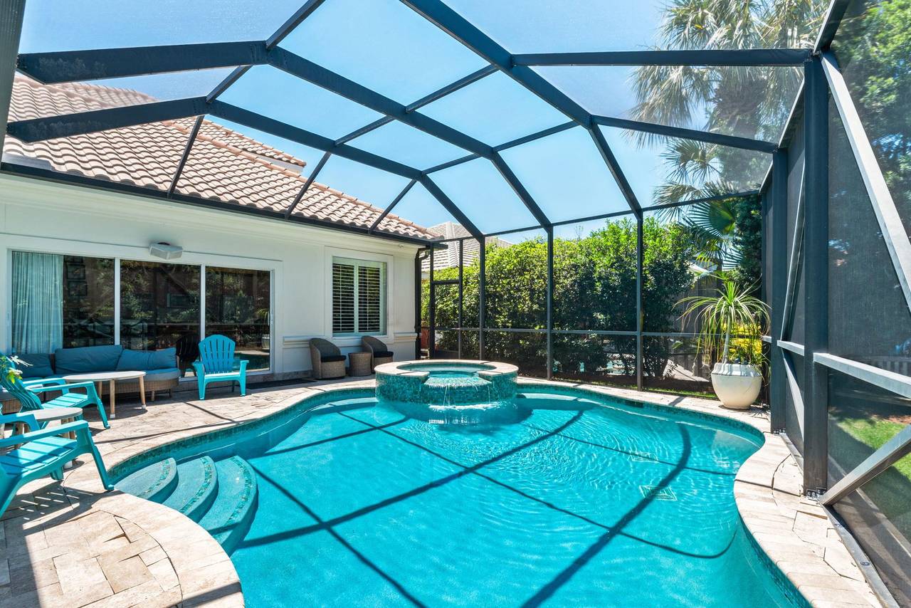 take a refreshing dip in your private screened pool, then relax on the sun loungers