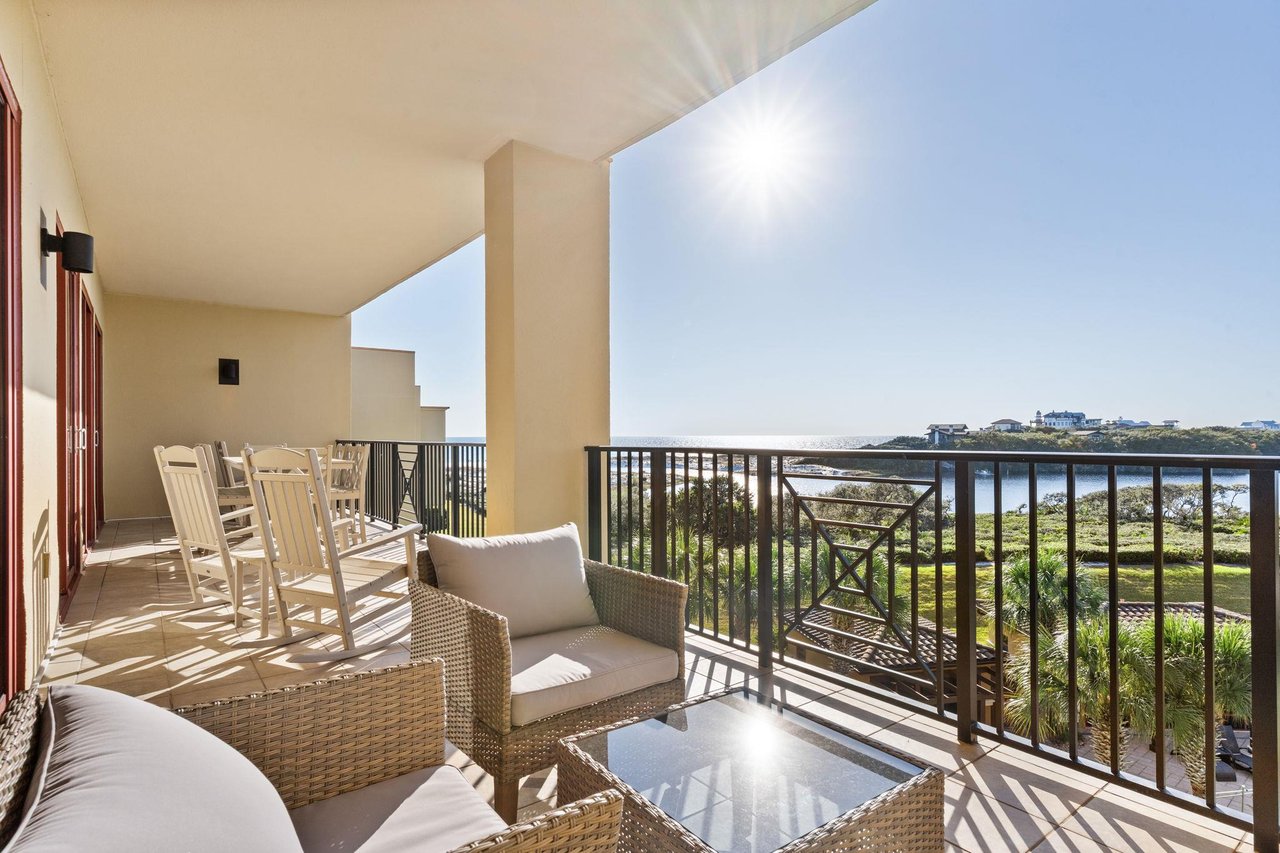 a balcony with a patio and chairs