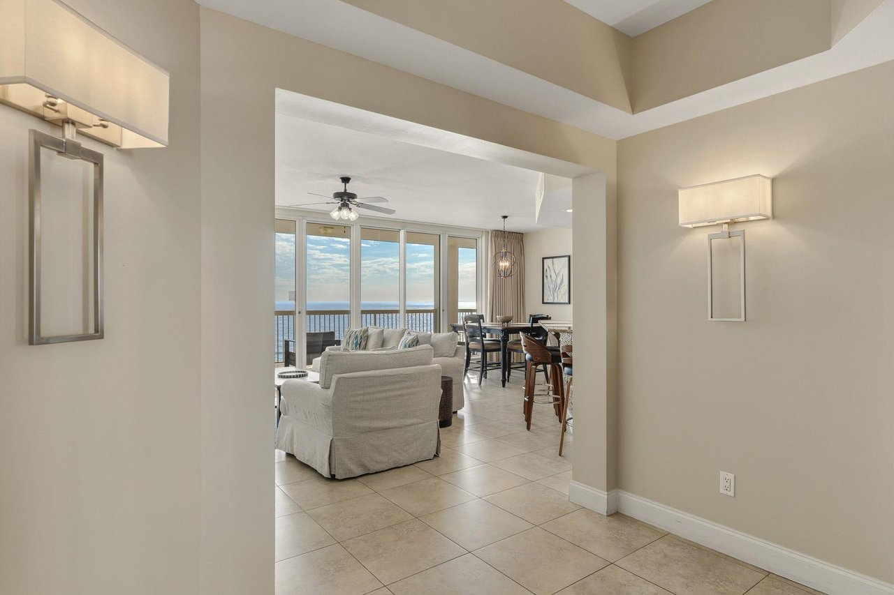 Step into your elegant coastal retreat where ocean views frame the open living space, perfect for relaxing after beach days.