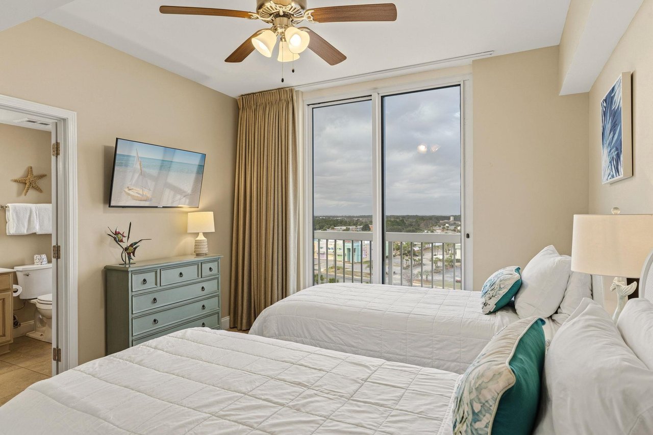 Bedroom 3 Wake up to city and bay views from your comfortable beds with gentle ceiling fan breezes and beachthemed decor creating your perfect seaside retreat.