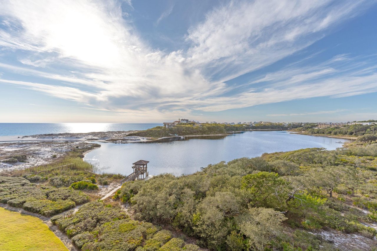 Stunning coastal lagoon with pristine waters, lush vegetation, and charming observation tower creating a peaceful natural sanctuary.