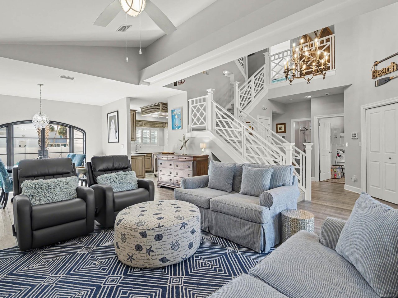 Relax in your openconcept living space featuring soaring ceilings, plush seating, and coastal charm that makes every moment feel like vacation.