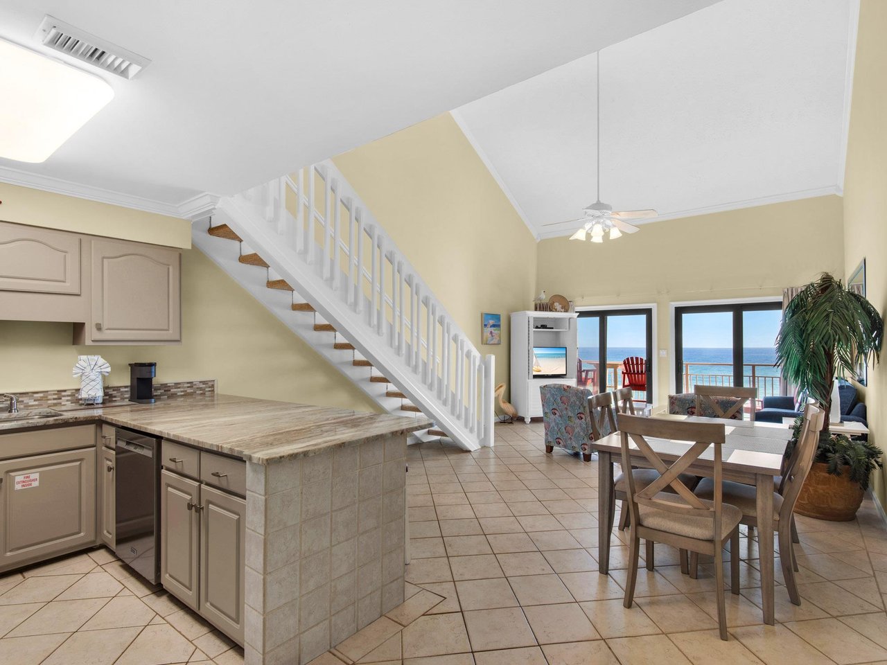 Openconcept living space where you can cook, dine, and relax while enjoying stunning ocean views through sliding glass doors.