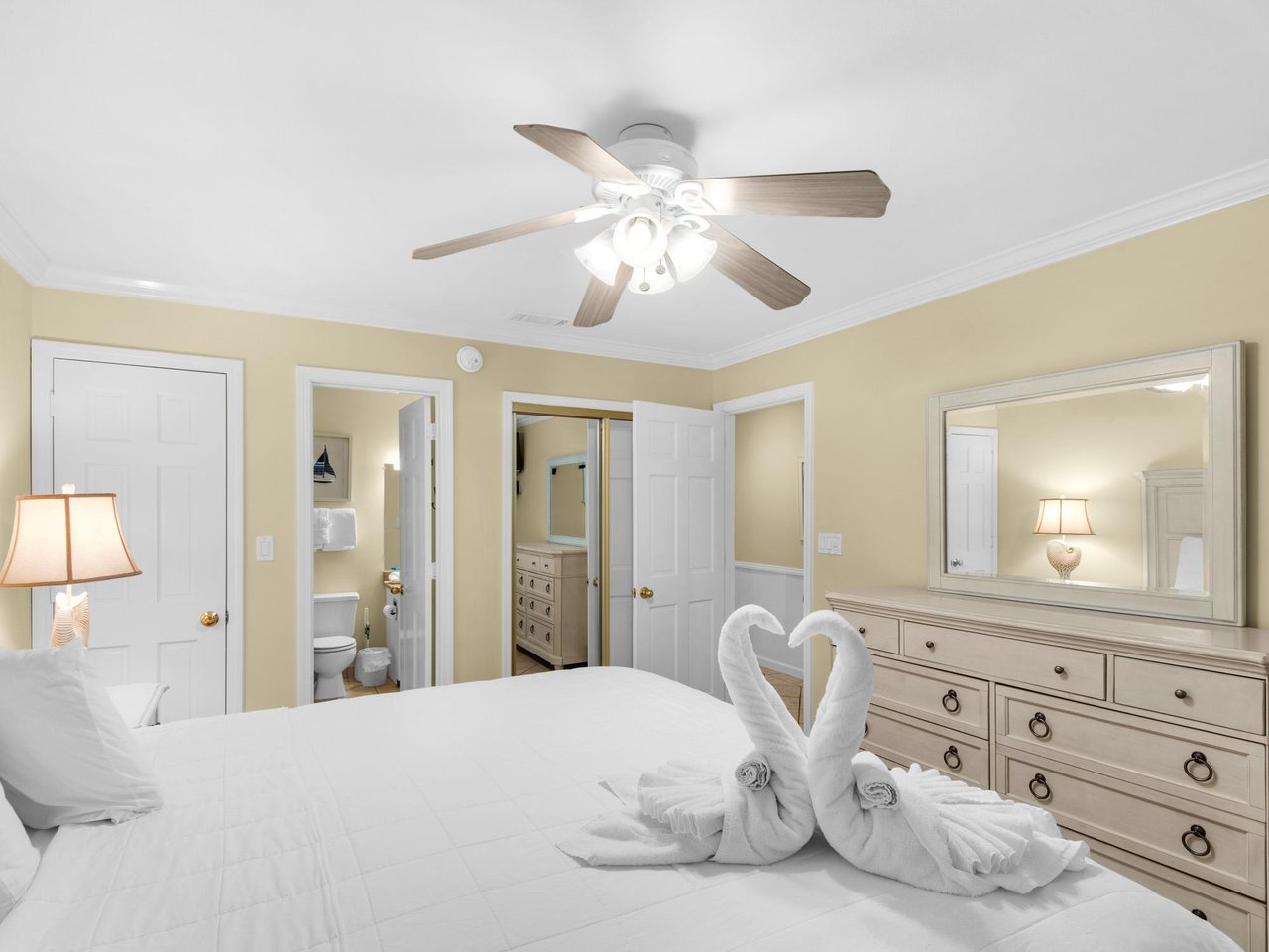 Your peaceful bedroom sanctuary features a comfortable bed, elegant furnishings, and charming towel swans awaiting your arrival.