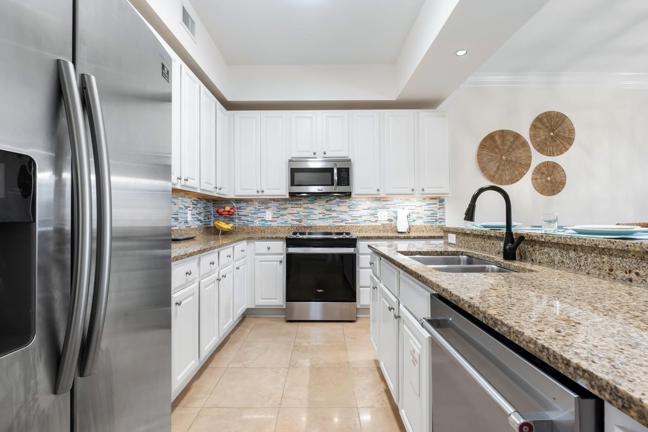 Bright, open kitchen with ample space to prepare family meals in a breezy, coastal setting.