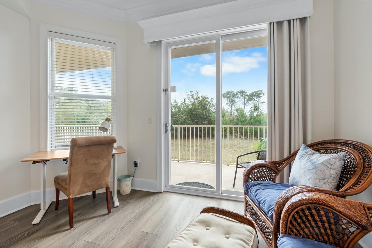 Spacious Primary King Suite featuring a comfortable desk area for work or planning your day.
