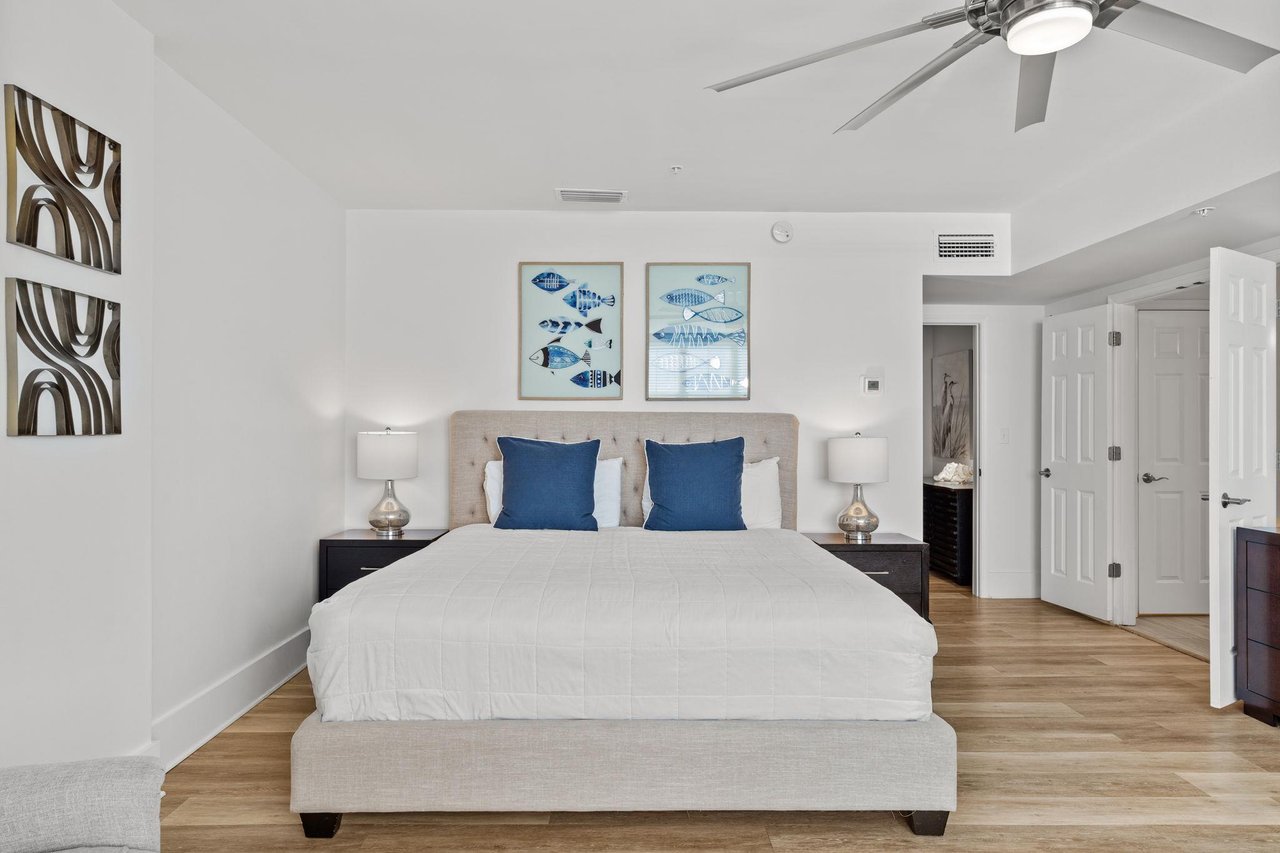 The 2nd floor master suite with nautical artwork and plush  bedding.