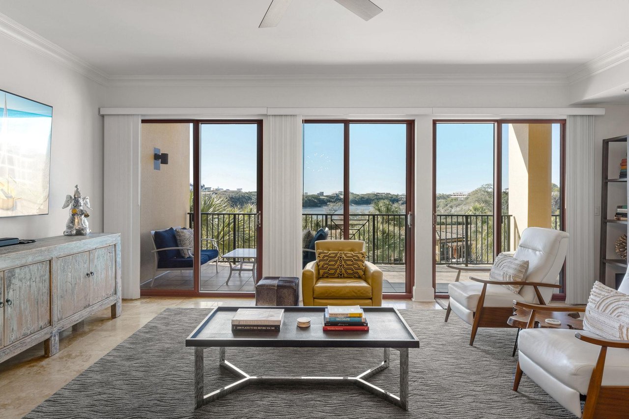 Natural light streams through the private balcony with stunning gulf views.
