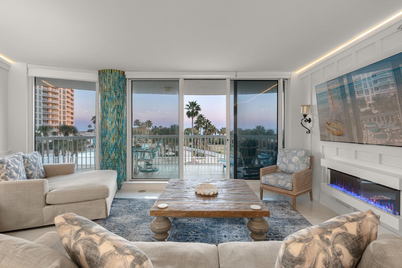Relax with stunning water views, cozy fireplace, and direct balcony access to tropical scenery.