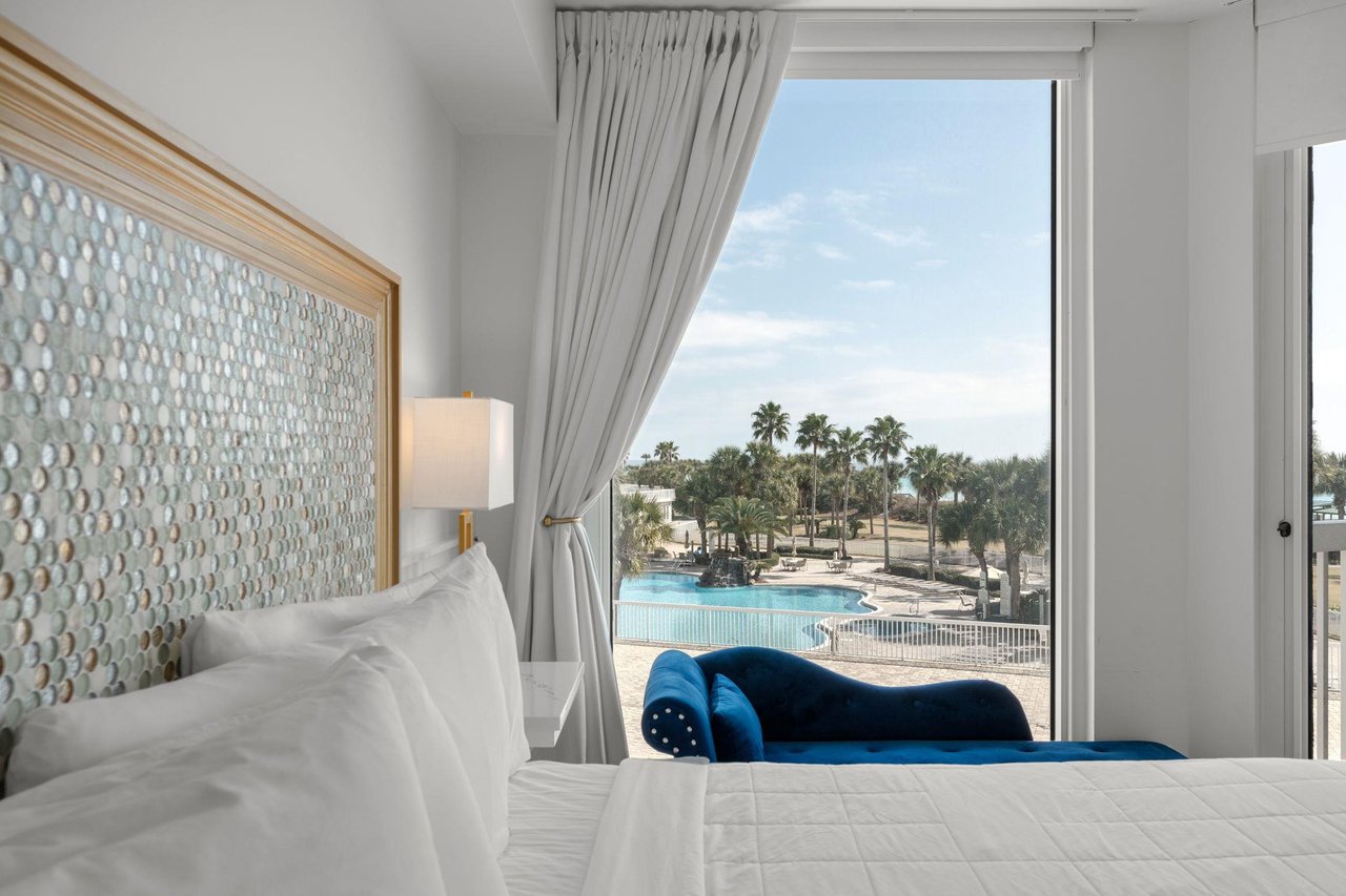 Wake up to stunning pool and tropical views from your elegant bedroom, where comfort meets paradise.
