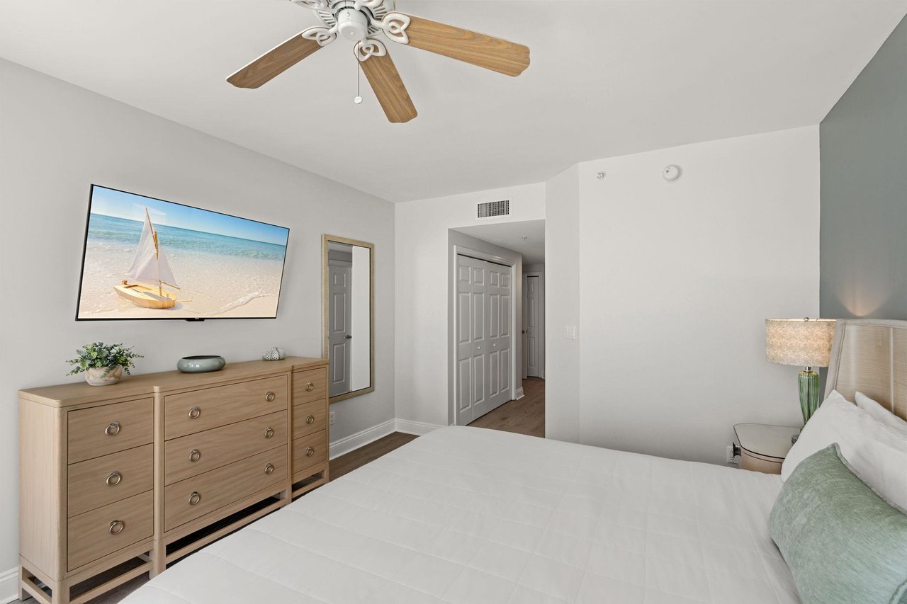 Unwind in your peaceful bedroom where coastal artwork and soft lighting create the perfect atmosphere for restful nights and relaxed mornings.