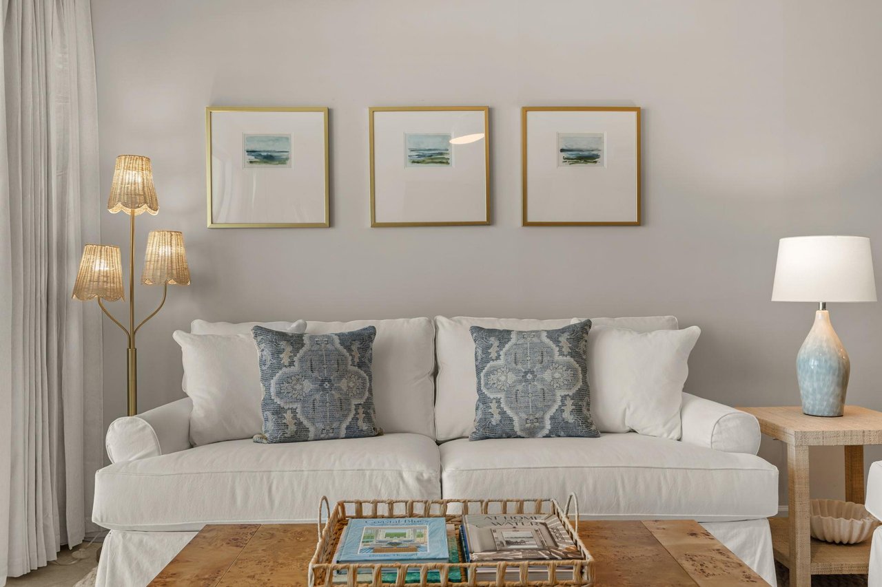 Sink into plush cushions while ocean artwork and soft lighting create your perfect coastal retreat.