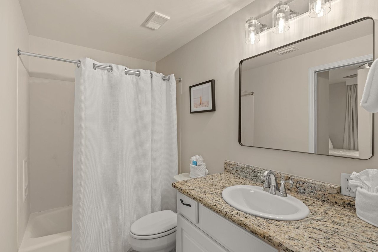 Step into your sparkling clean bathroom featuring granite countertops, elegant lighting, and fresh towels waiting for you.