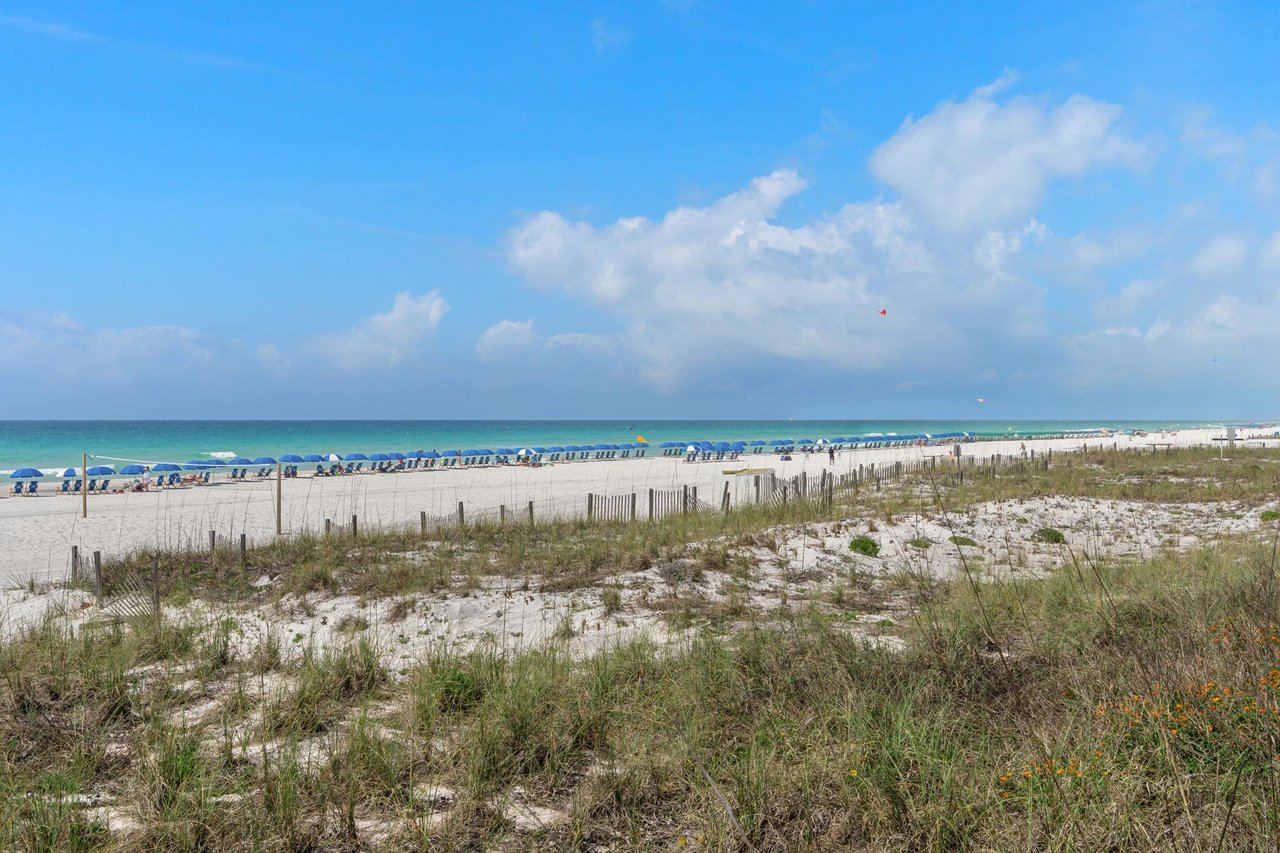 Beautiful pristine beach with turquoise waters and white sand, perfect for relaxation and seaside activities.