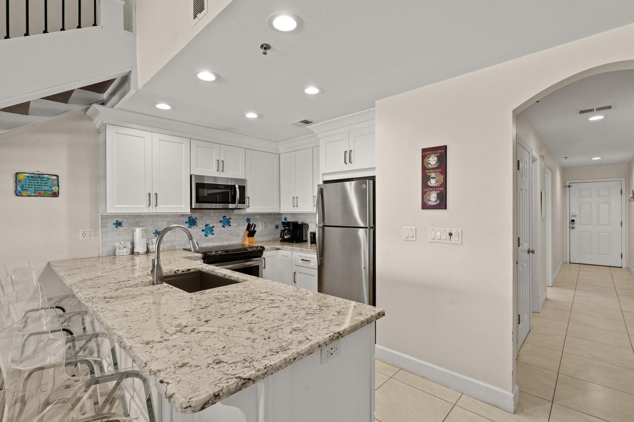 Your bright, modern kitchen features granite countertops, stainless steel appliances, and an open layout perfect for preparing meals and gathering with loved ones.